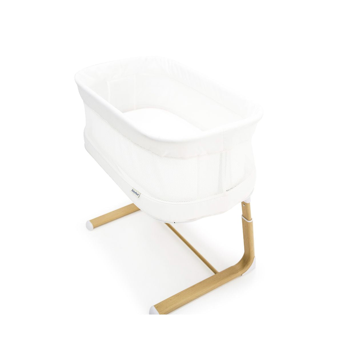 White baby crib with wooden legs on a white background