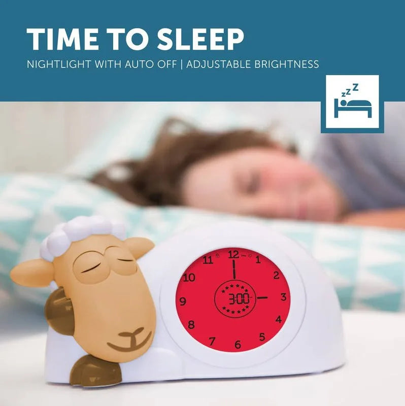 Sleep aid clock with sheep design and adjustable brightness feature, displayed in a bedroom setting.