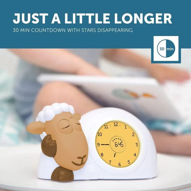 Sleep aid clock with sheep design and text 'Just a little longer' on a blue background